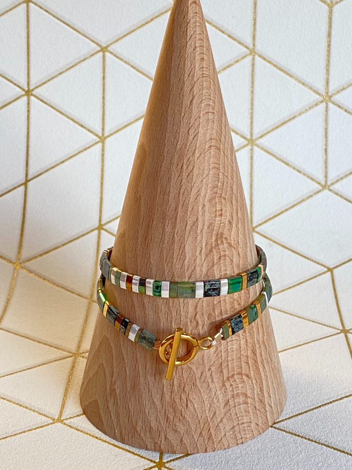 Le bracelet DOUBLE VITAMINES VERT KAKI peut se porter avec son fermoir "T" de façon visible ou non, selon votre préférence. Les bracelets DOUBLES VITAMINES créés par Les jolis hasards sont composés de perles de verre Miuyki fabriquées au Japon et d'une qualité incomparable. Ils sont montés entièrement à la main sur un fil de nylon (plus résistant que l’élastique) qui permet de faire deux fois le tour du poignet.